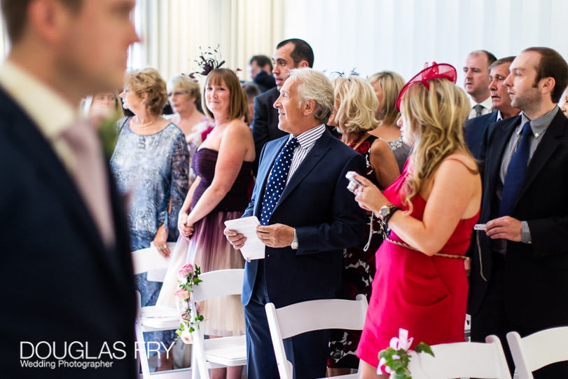 Guests waiting for bride at wedding at Coworth Park