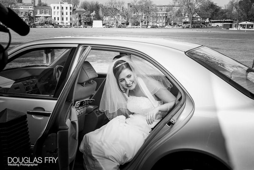 bride arriving by car photographed at Cambridge Cottage Kew by wedding photographer