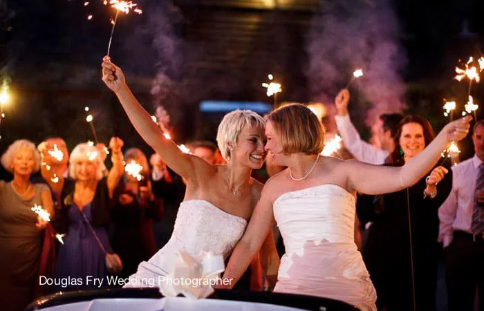 Wedding Photographer London Photograph of brides in car with sparklers Sussex