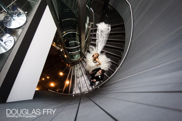 Bride and groom photographed on stair case at Gherkin