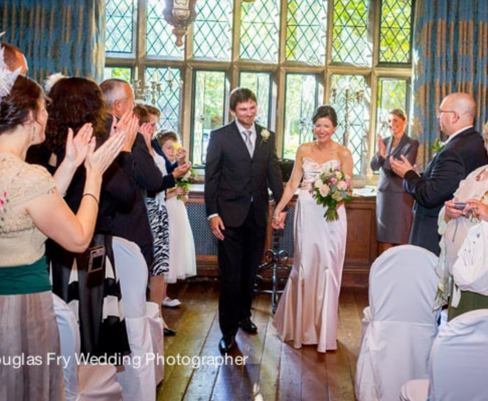 Couple leaving ceremony at Great Fosters