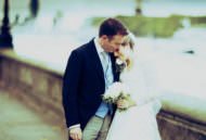 Wedding photograph of couple on embankment near Chelsea Old Church