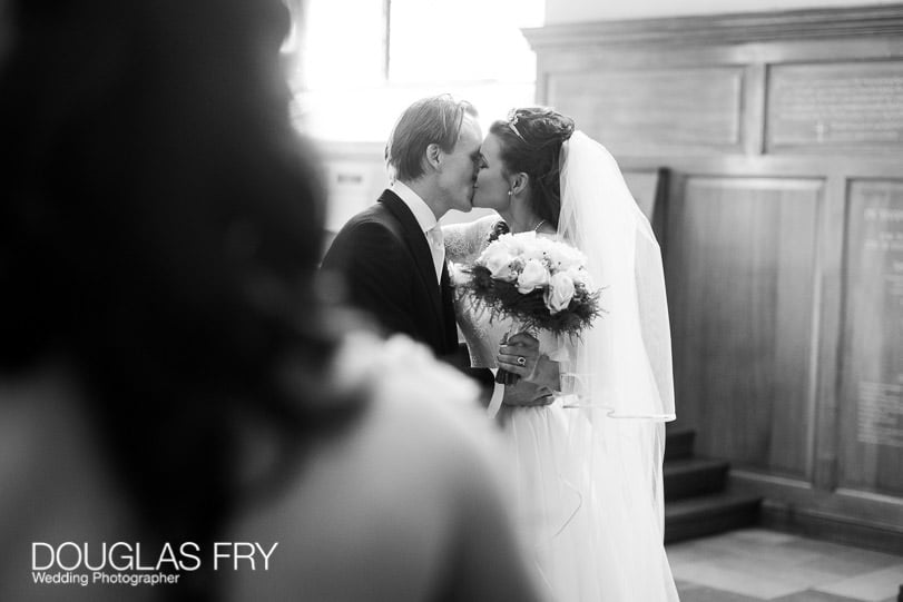 Wedding Photographer St Brides Church London - kiss in church