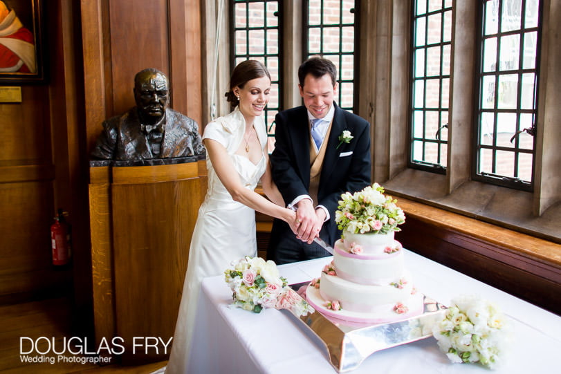 Couple cutting wedding cake at Grays Inn London