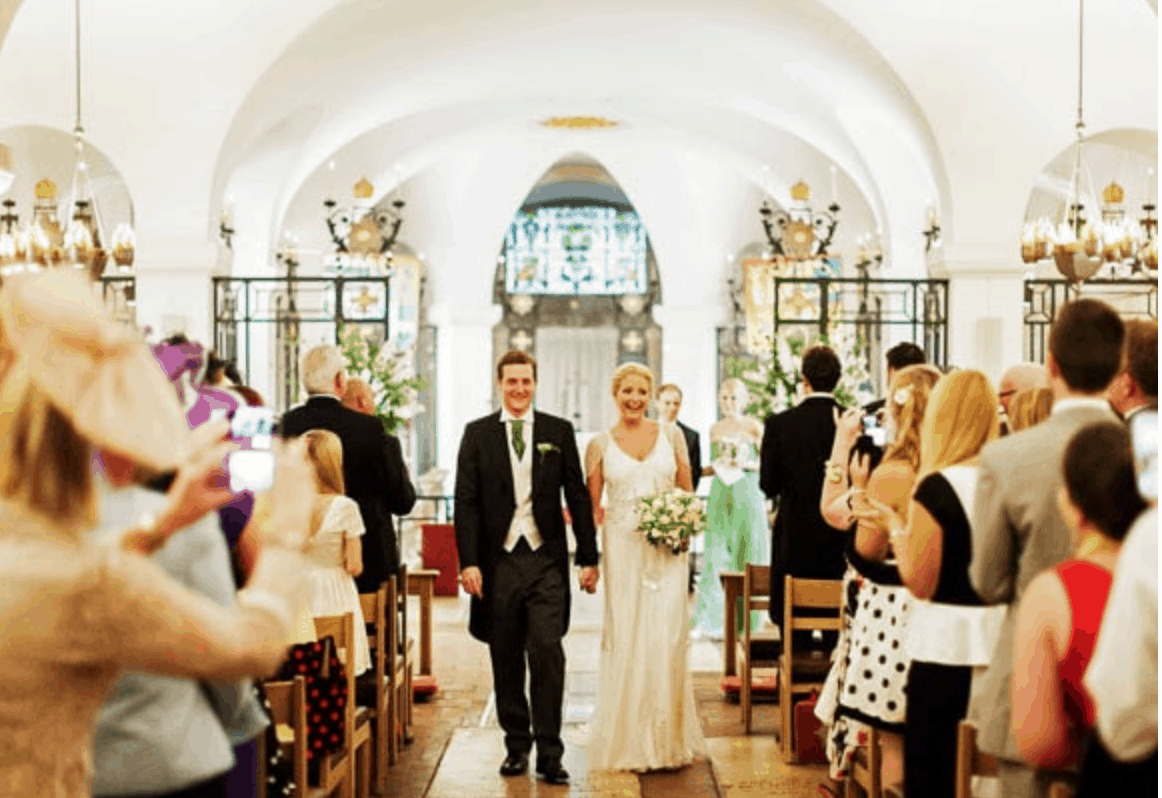 Couple walking down the aisle to leave St Paul's Cathedral