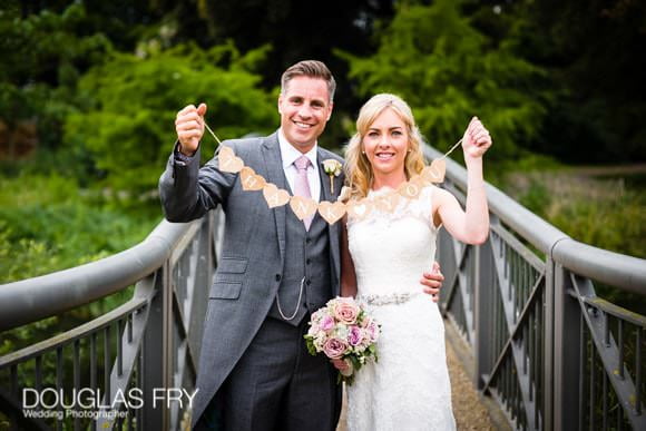 Wedding Photograph of couple holding thank you sign