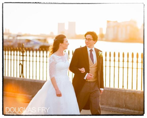 Wedding couple walking next to the river in Greenwich. Caught in the evening light.