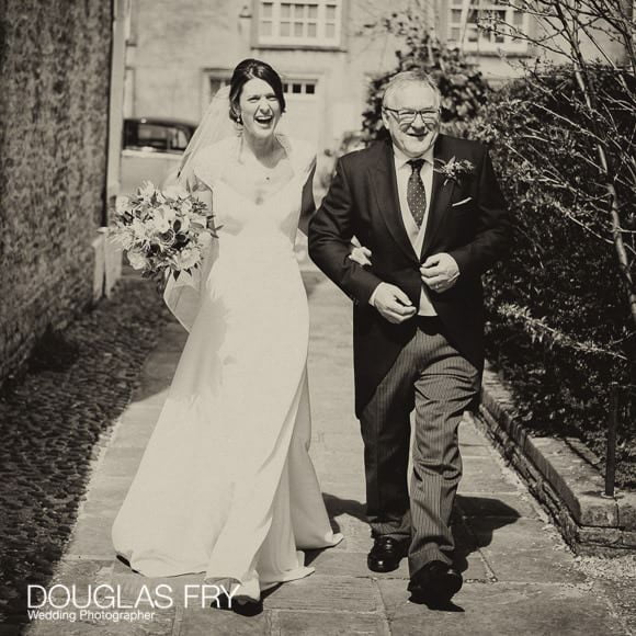 Wedding Photographer Woodstock and Blenheim Palace in Oxfordshire 2 Bride and Father walking to Church down path - black and white photograph