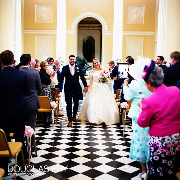 Bride and groom leaving the wedding ceremony at Syon