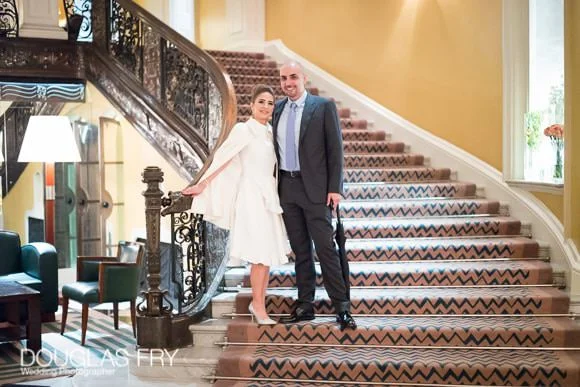 Wedding Dinner at The Mandarin Oriental - Getting Ready Photography at Claridges Hotel 3 Couple on stairs in Claridges Hotel - Colour photograph