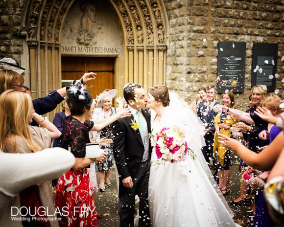 Confetti wedding photograph in front of Farm Street Church in London