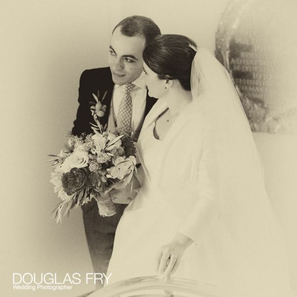 Sepia photograph of bride and groom at Cafe Royal in London