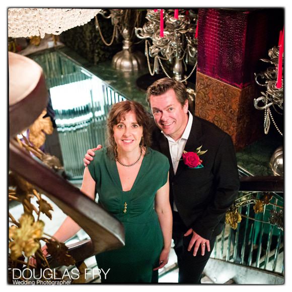 Bride and groom photographed together on stairs at Crazy Bear Hotel