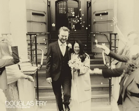 Saturday's wedding at Woolwich Register Office and The Gun, Docklands 6 Black and White photograph with confetti as bride and groom leave register office in London