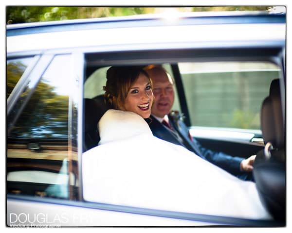 Bride and father of the bride arrriving in car at wedidng venue taken on Leica cameras