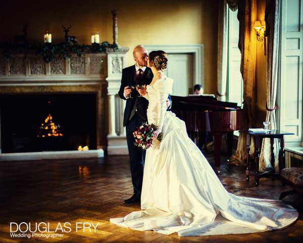 Bride and groom in front of fire at Hampton Court House - Leica picture