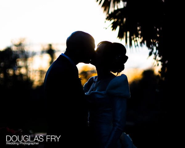 Bride and groom kissing outside Hampton Court House - Leica photograph