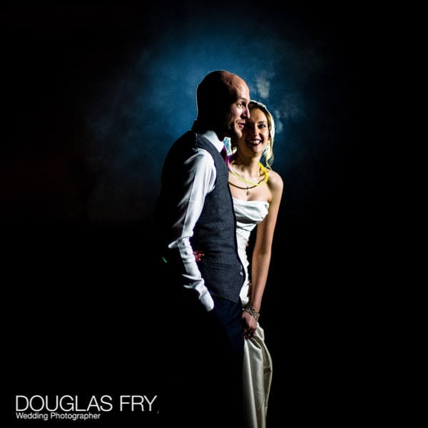 Photograph taken on Leica camera and lens at wedding at Hampton Court House of bride and groom outside watching fireworks