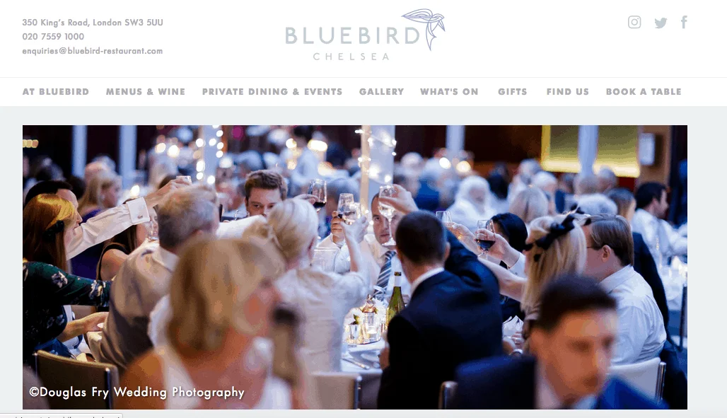 Bluebird wedding reception photographed by Douglas Fry Photograph of guests seaed during wedding breakfast at Bluebird in London