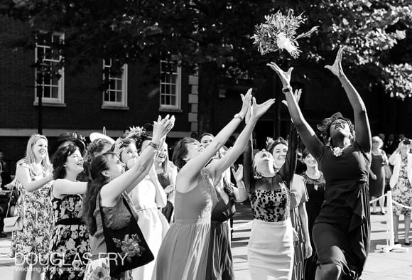 Bridesmaid catching bouquet in Chelsea - black and white wedding photograph