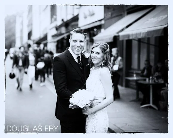 Laura and Andy's Wedding Photographed at Soho Hotel and the Union Club 7 black and white photograph of bride and groom in London street in front of cafe