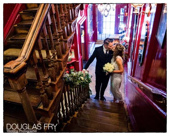 Laura and Andy's Wedding Photographed at Soho Hotel and the Union Club 9 Bride and groom kissing on staircase in Union Club