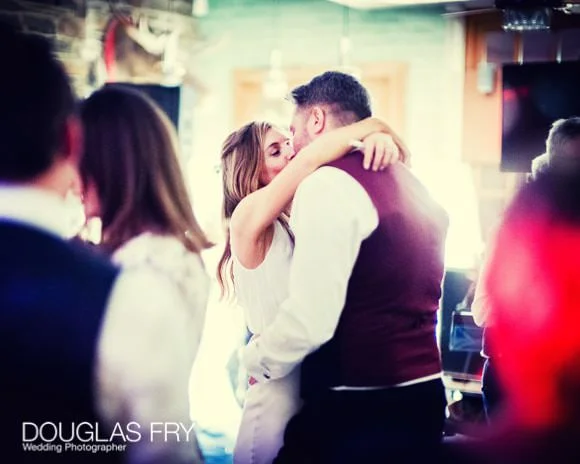 Laura and Andy's Wedding Photographed at Soho Hotel and the Union Club 11 Bride and groom kissing during dancing phase of the day