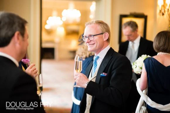 Wedding Photographer The Cavalry and Guards Club - Tara & Tim 10 Guests in convesation at Cavalry and Guards Club