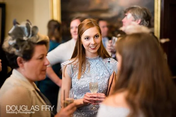 Wedding Photographer The Cavalry and Guards Club - Tara & Tim 8 Guest in conversation picture by Douglas Fry