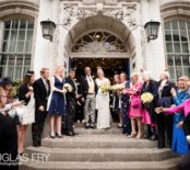 Photograph of bride and groom on steps of register office after wedding ceremony in London