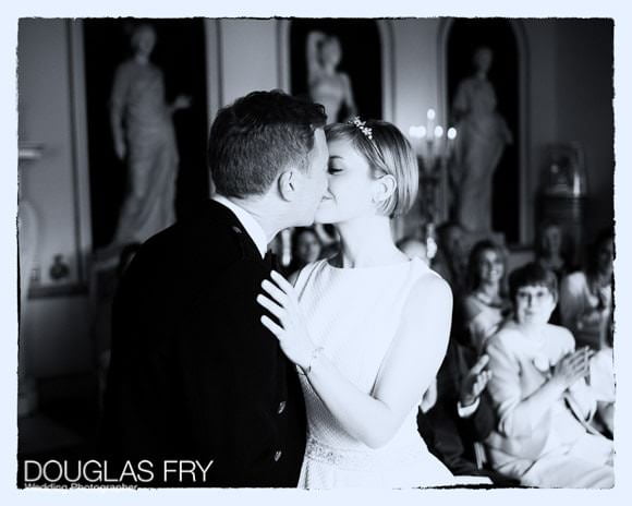 Black and white photograph of couple kissing after ceremony at Syon