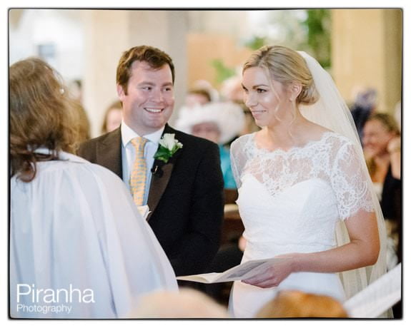 Bride and groom in church pictured during ceremony at Crudwell Church