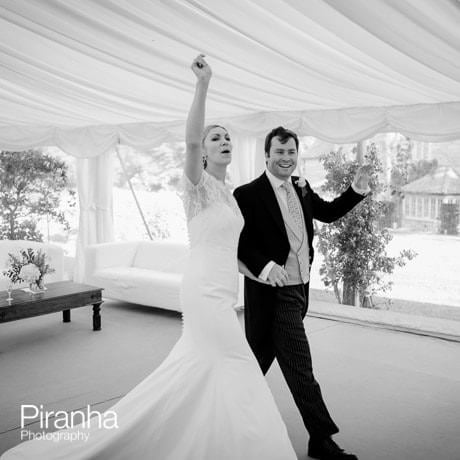 Bride and groom entering marquee for wedding breakfast