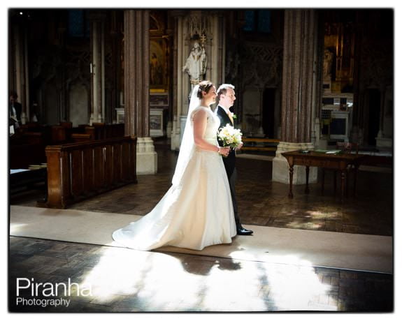 Bride and Groom walking down aisle in Farm Street Church