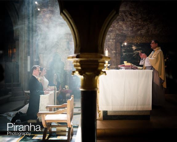 Wedding service with priest photographed in Farm Street Church