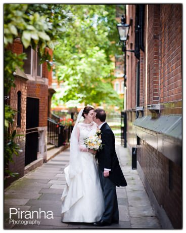 Kiss in London street for bride and groom on wedding day