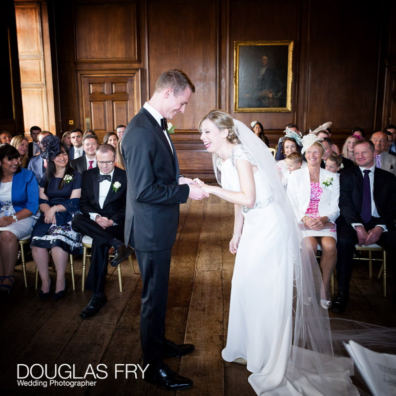 Bride and groom laughing during ring exchange at civil ceremony