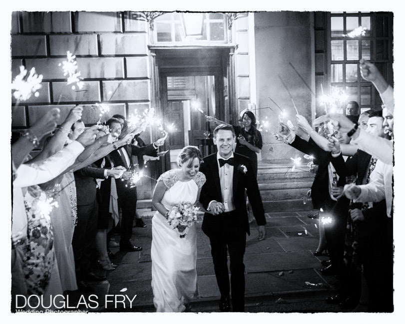 Bride and groom photographed going away through sparklers at Admirals House in Greenwich