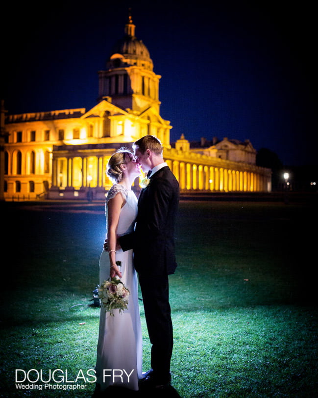 Bride and groom photographed illuminated outside the Old Royal Naval College in Greenwich