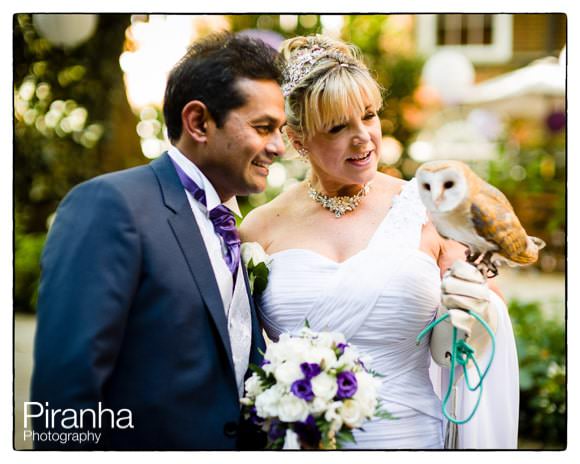 Couple with bird of prey at wedding reception at Stationers' Hall in london