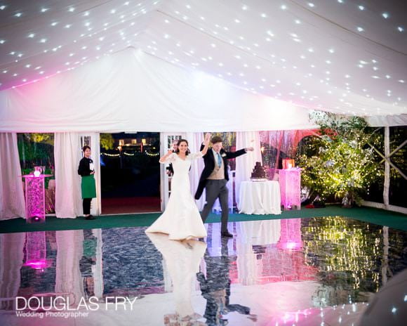 Bride and groom entering marquee - mirrored dance floor