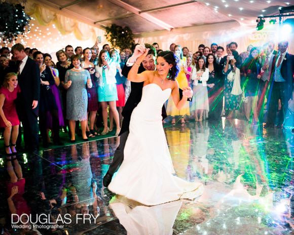 Bride and groom dancing on mirrored dance floor