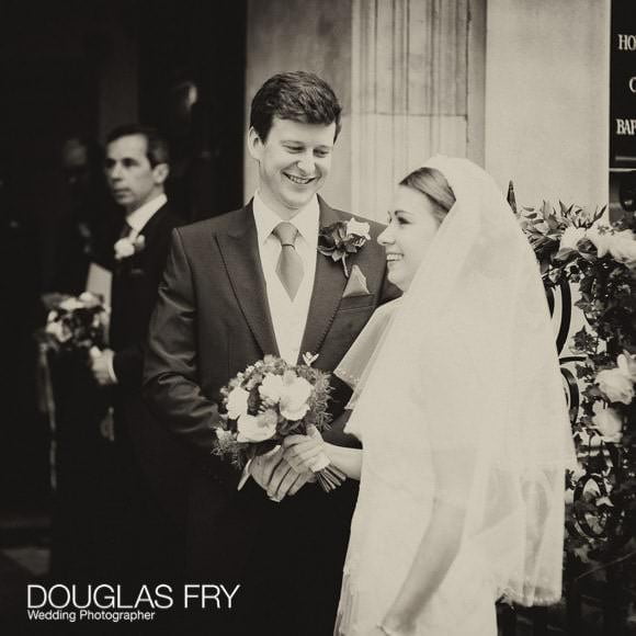 Black and white photograph of bride and grooming leaving church