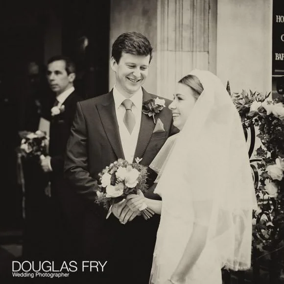 In and Out Club Wedding Photographer (Naval and Military Club) for Charlotte and Robert 4 Black and white photograph of bride and grooming leaving church