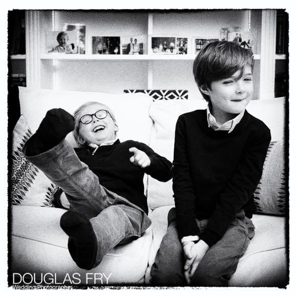 Two boys in black and white photographed at home