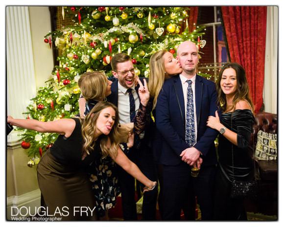 In and Out Club wedding photograph of guests in front of Christmas tree