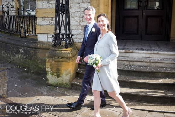 Bride and groom wedding photograph as they walk away from Oxford Register Office
