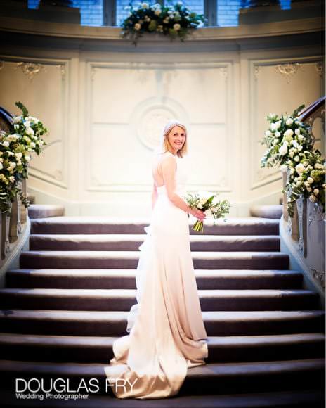 Bride ascending the stairs at the Savile Club in London