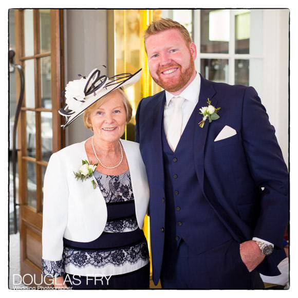 Groom and mother at church ready for wedding to begin.