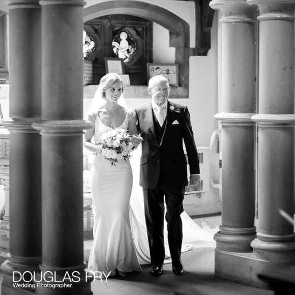 Bride and father arriving at church for wedding service